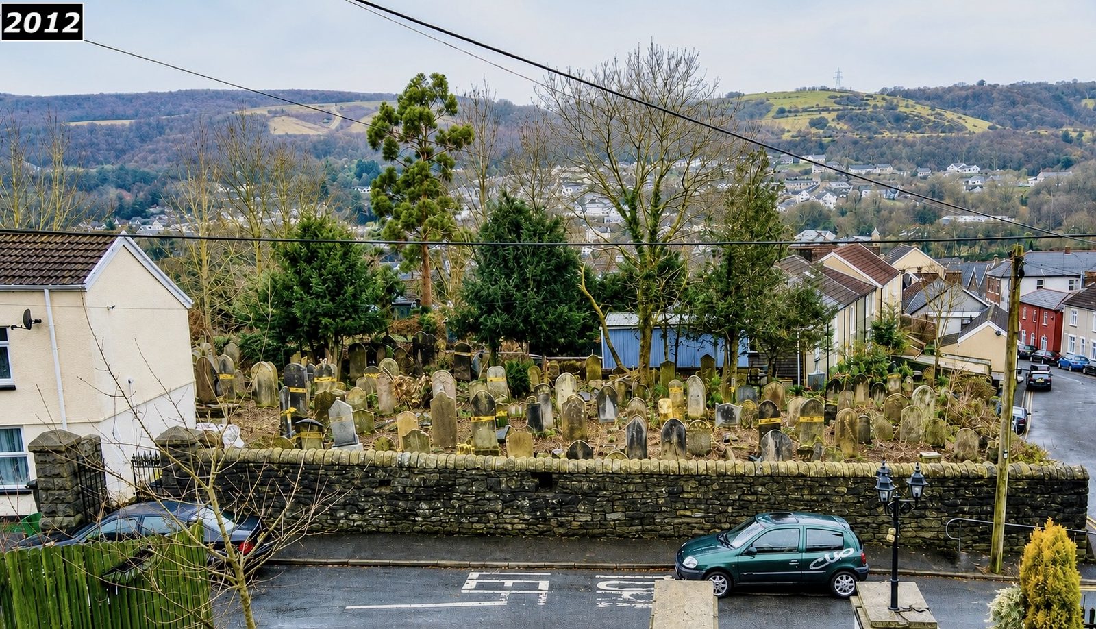 View across Saron graveyard in 2012 looking over the boundary wall towards Troedyrhiw village