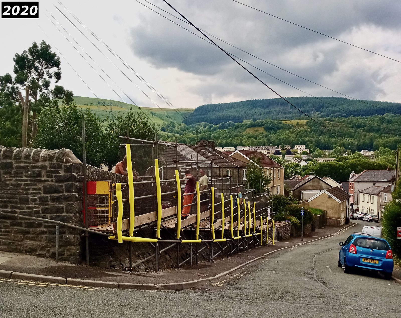 Yellow scaffolding supports holding headstones during stabilisation works at Saron in 2020